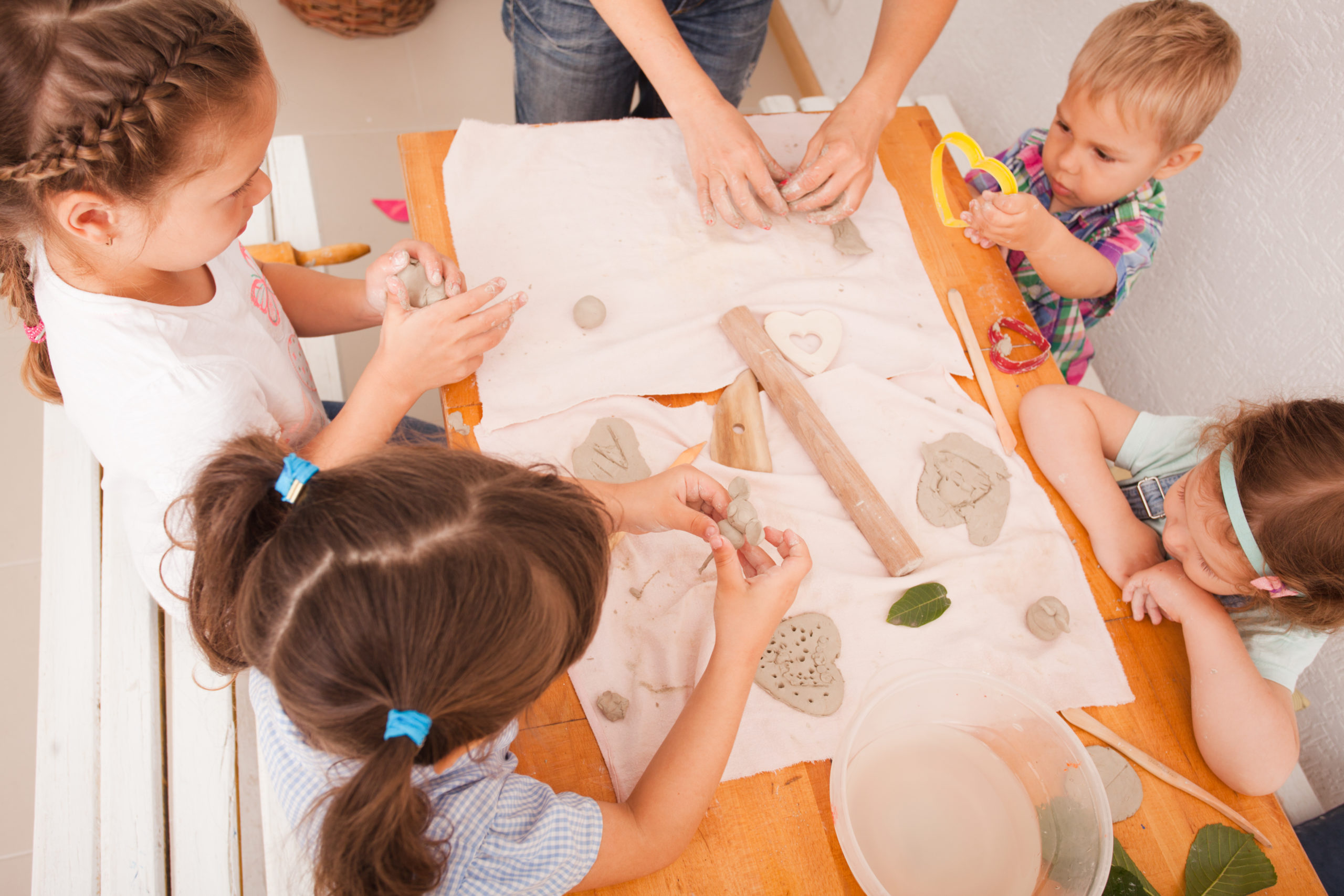Happy children are engaged with modeling clay